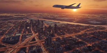 Bustling U.S. city at sunset with an airplane, symbolizing extended travel through free stopovers.